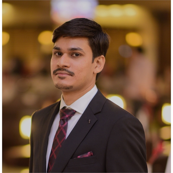 Muhammad Umar Tarique Khan in suit staring towards the camera